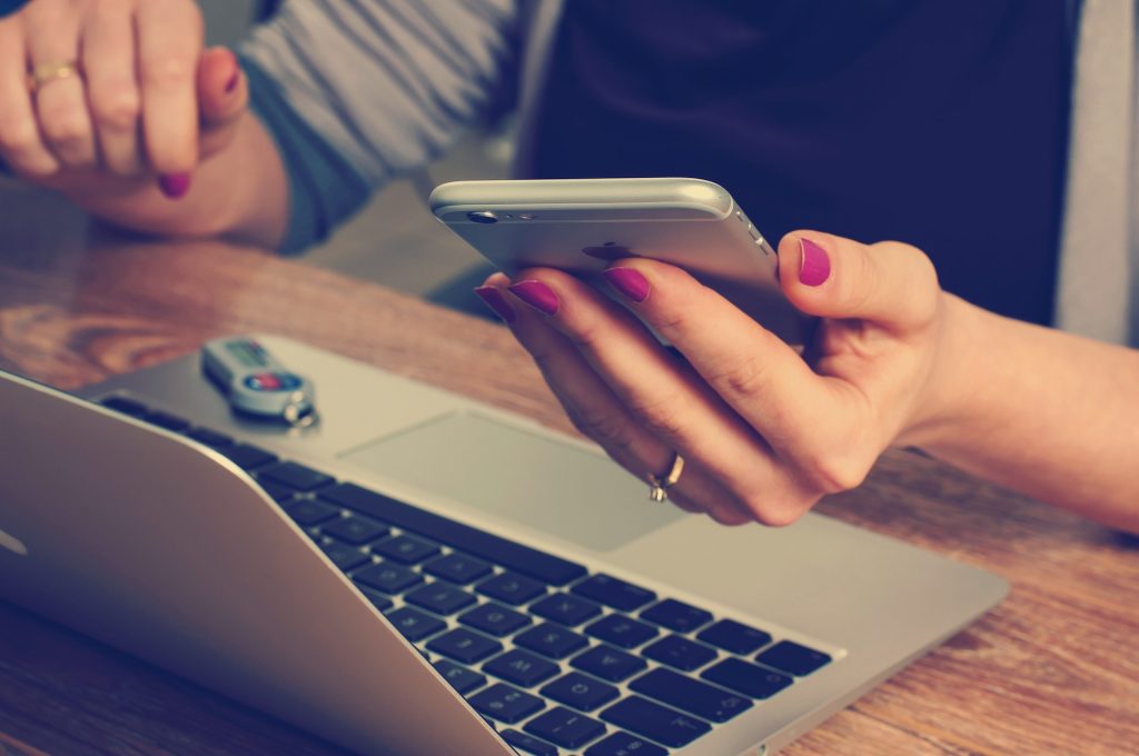 Woman on computer and phone