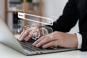 Typing on a laptop with graphic indicating search and artificial intelligence