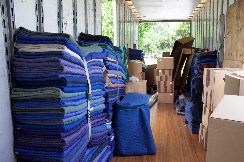 Moving Blankets and boxes stacked in a moving truck